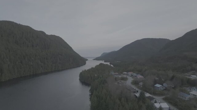 Aerial view of a remote coastal inlet and forested shoreline in the Great Bear Rainforest, British Columbia &mdash; slow push over the shoreline