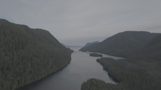 Aerial view of forested islands in a calm coastal fjord on the British Columbia coast &mdash; slow orbit over the islands