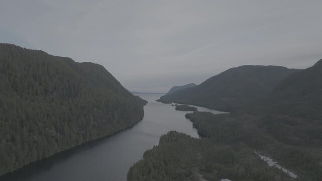 Aerial view of forested islands in a calm coastal fjord on the British Columbia coast &mdash; wide establishing shot