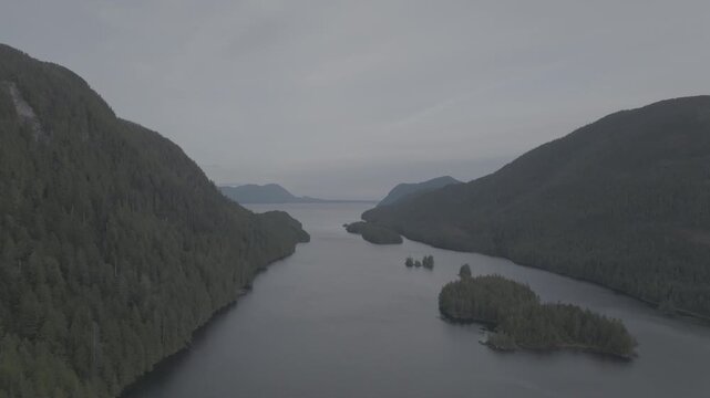 Aerial view of forested islands in a calm coastal fjord on the British Columbia coast &mdash; high angle over the archipelago