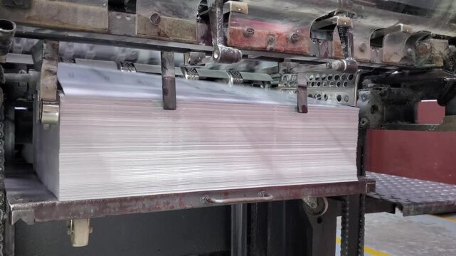 Close-up of industrial printing press rollers and paper feeding process
offset printing, printing press, industrial printing machine, print shop operation, printing factory, commercial printer, paper 