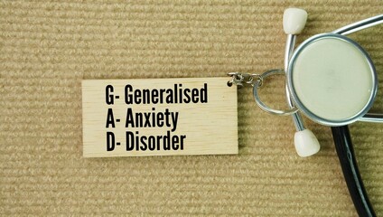 Stethoscope and wooden keychain with the words Generalized anxiety disorder GAD. mental health condition defined by persistent, excessive, and uncontrollable worry about everyday things like health © Fauzi