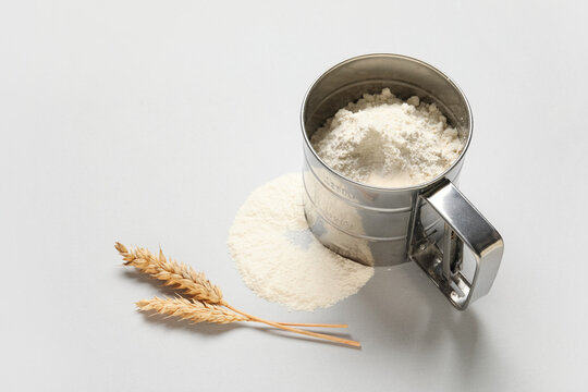 Baking and culinary preparation, flour sifter with wheat ears for homemade bread and pastry cooking ingredients on a clean light gray background