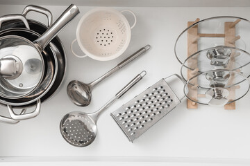 Obraz premium Kitchen organization and home cooking, stainless steel cookware and utensils arranged in a clean drawer for efficient meal preparation and storage