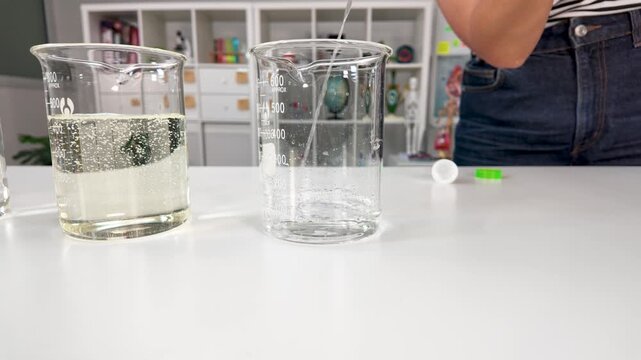 Glass Beakers with Liquid on Table in Science Laboratory Classroom