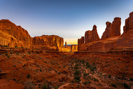 Park Avenue monoliths glow under golden sunrise light Utah