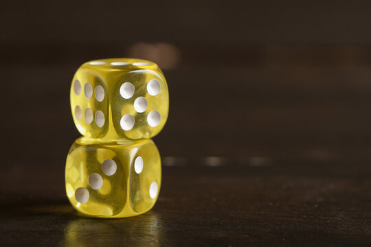 Yellow game dices on wooden background