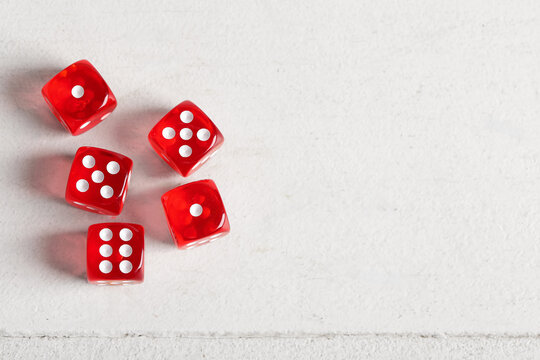 Red game dices on white wooden background