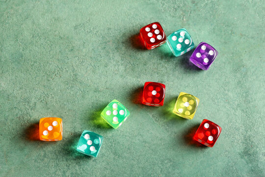 Colorful game dices on green background