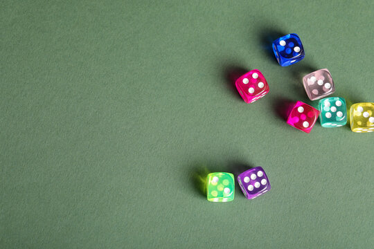 Colorful game dices on green background