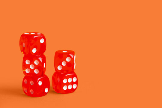 Red game dices on orange background
