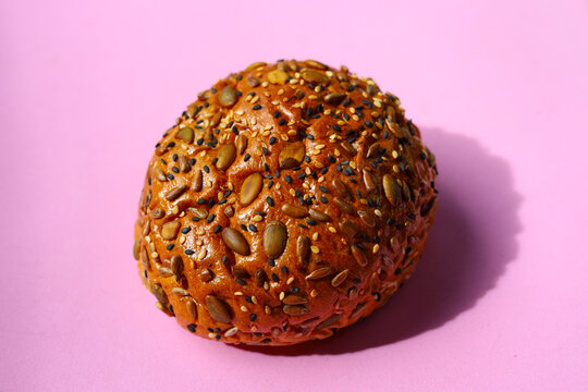 Healthy multigrain bread bun topped with mixed seeds and grains