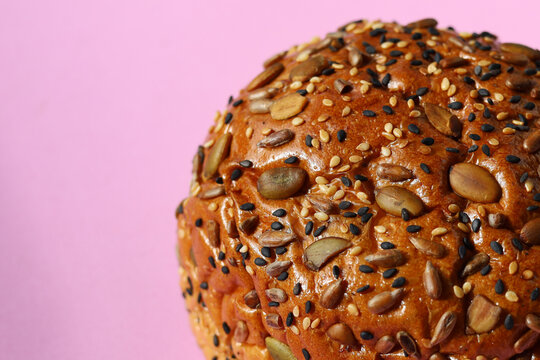 Healthy multigrain bread bun topped with mixed seeds and grains
