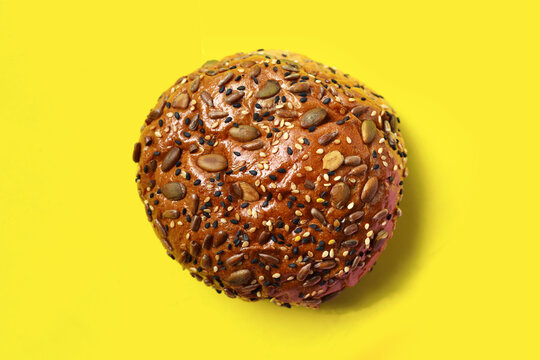 Healthy multigrain bread bun topped with mixed seeds and grains