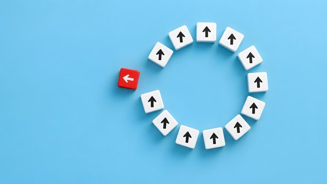 Disruption and standing out concept featuring a red arrow block breaking away from a circular pattern of white arrows