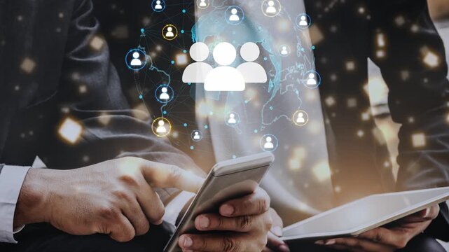 Business professionals using smartphone and tablet with digital network connection and social media icons in background, showcasing technology and communication. Entropy.