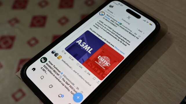 Industry news post featuring ASML and TSMC logos on social media feed displayed on mobile phone screen on desk. Kolkata, West Bengal, India, September 11, 2026