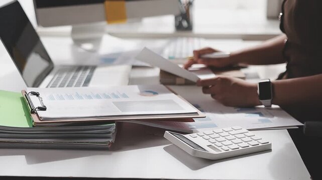 Businesswoman holding document working at laptop pc computer doing online tax invoice, financial report. Focused Hispanic business woman manager specialist with paperwork in office. Banner, copy space