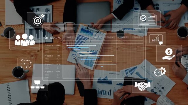 A diverse team works on business analytics in a modern office, utilizing charts and graphs to enhance project management and drive collaborative success. Raster