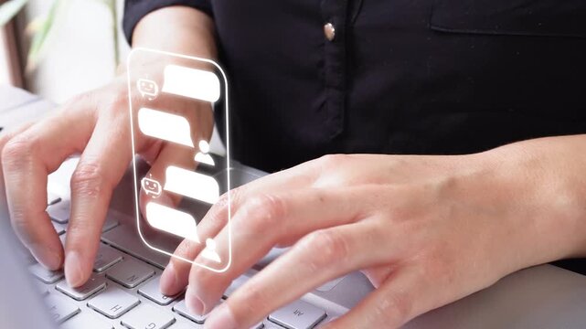 Close-up shot of a businesswoman working on her computer, with an animation showing a chat interface with a bot on a smartphone.