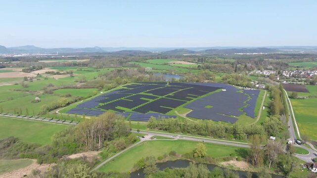 Aerial view, solar modules, solar park, photovoltaics, power generation from solar energy on a former landfill site near Radolfzell on Lake Constance, the Hegau mountains on the horizon, district of 