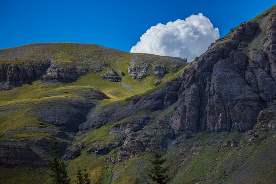 Mountain tundra cliff with pools of light and distant cloud