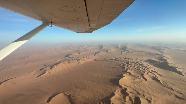 View from the plane over endless sand dunes of the Namib Desert, impressive desert landscape, sightseeing flight in the evening light, aerial view, Namib-Naukluft National Park, Namibia
