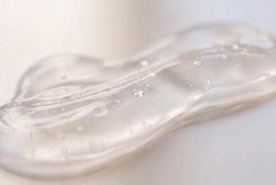 transparent gel texture with water droplets on soft neutral background