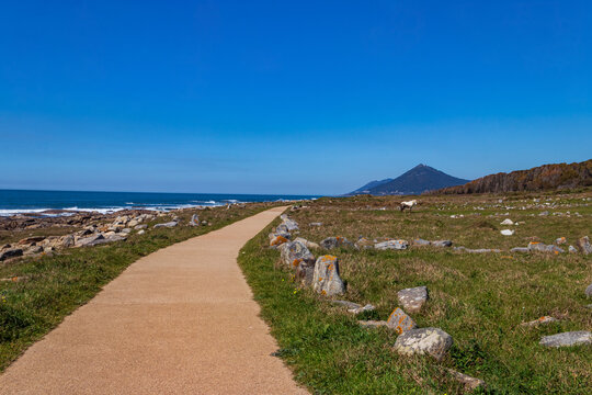 Scenic view of the Ecovia Litoral Norte paved path along the Atlantic Ocean with Mount Santa Tecla on the horizon near Vila Praia de Ancora, Portugal