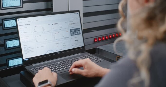 Female IT Specialist Responds to Cyber Attack Alert Using Linux Command Line, Reviewing Server Telemetry and Performing Emergency Recovery Steps During Critical Infrastructure Security Incident.