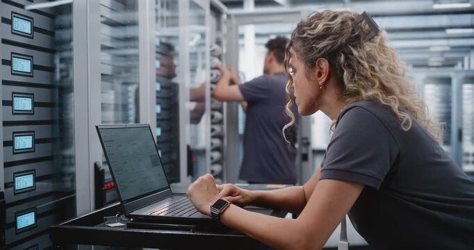 Female Cybersecurity Engineer Analyzes Cyber Attack Warning Through Terminal Interface, Checking System Health and Applying Emergency Console Procedures to Protect Critical Data Center Infrastructure.