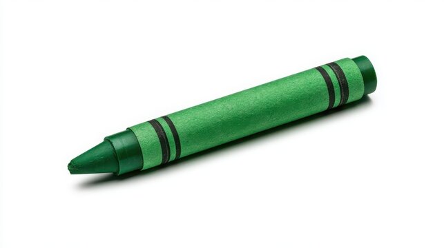 Green crayon rests diagonally across a stark white surface casting a soft shadow beneath its paper wrapped tip.
