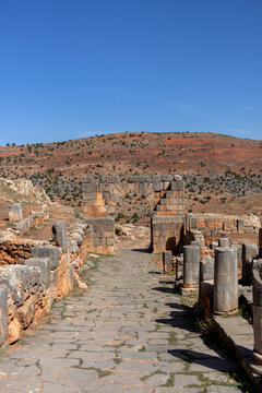 Paved Roman Street Leading to a Standing Arch at the Tiddis Hilltop Ruins Algeria