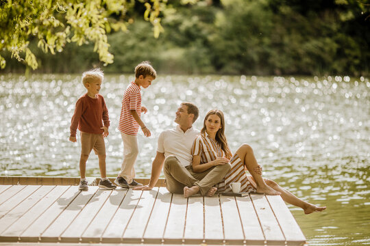 Family enjoying a sunny day by the tranquil lakeside