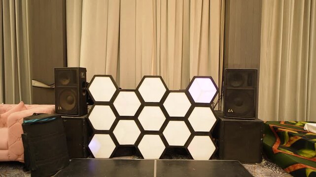 Modern event stage setup with hexagonal light panels in a Delhi banquet hall