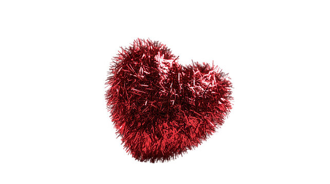Red tinsel heart ornament with a fluffy texture isolated on a solid transparent background for Valentine's Day.