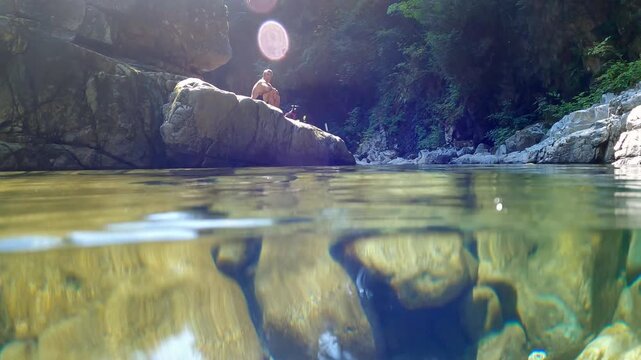 Snorkeling in Inter River Canyon in North Vancouver, British Columbia, Canada, with river surrounded by rocky canyon terrain and forest