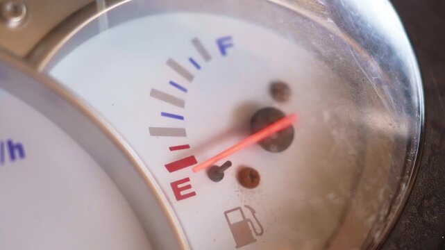 Detailed view of a classic scooter's dashboard, highlighting the analog speedometer and odometer with clear numerical readings.