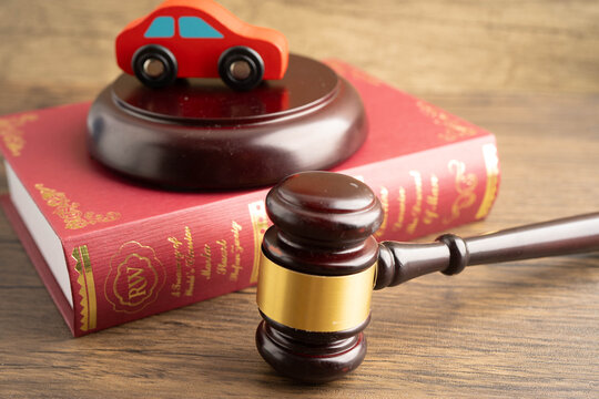 Car accident lawsuit and insurance, Judge hammer with car model.