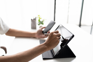 Using stylus on tablet for digital note taking and productivity technology concept. © Charlie's