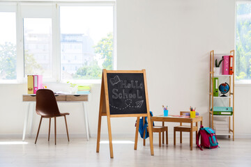 Homeschooling and remote learning, classroom setup with chalkboard and desk for children in a...
