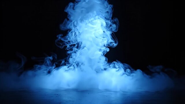 Mysterious blue spotlight illuminates a billowing cloud of smoke against a textured concrete wall photograph.