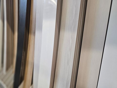 Display of wooden panels in various colors arranged in a row