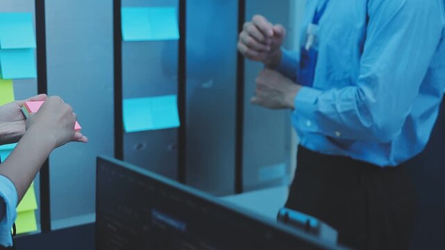 Asian happy woman and man programmer team coding software at computer in dark tech office, Concept of digital transformation, modern cyber security, startup teamwork and future IT digital network