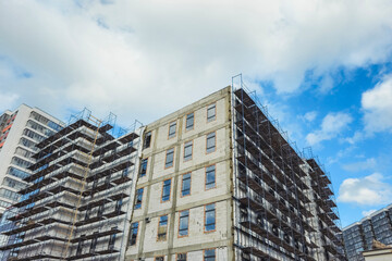 Fototapeta premium Primary real estate market concept with modern residential apartment building under construction