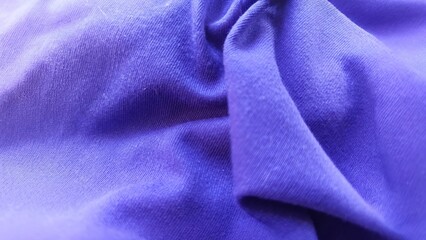 Close-Up View of Soft Purple Fabric Texture with Elegant Waves and Folds © Pedang