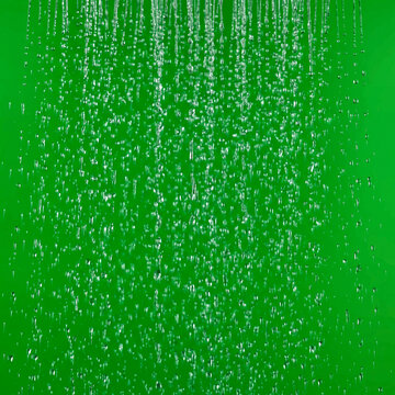 Studio Shot of Heavy Water Rain Shower Stream Droplets on Green Screen