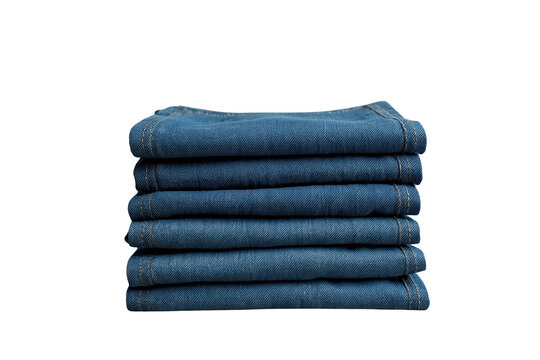 Neatly folded dark blue denim jeans stacked in layers