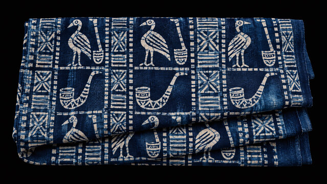 Nigerian adire indigo resist dyed cloth Yoruba pattern cassava starch bird motif deep indigo blue African textile museum illustration