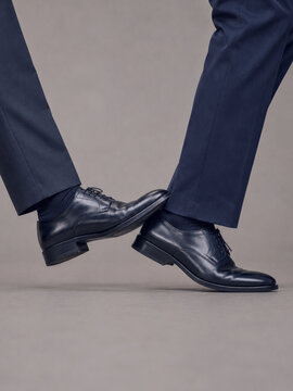 Businessmen in formal shoes tripping each other, concept for corporate rivalry, workplace competition, sabotage and professional conflict